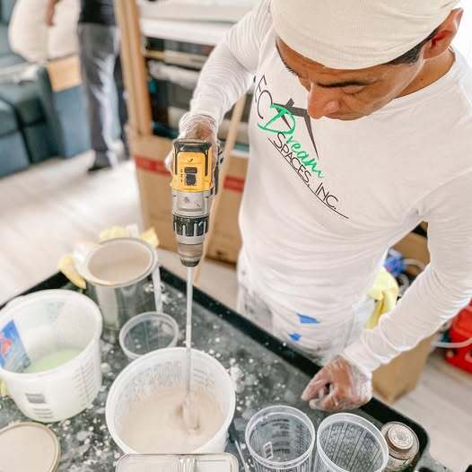 Professional interior painting prep by ECDreamSpaces. Lead painter Eliseo mixing custom colors for a home renovation, highlighting the company’s attention to detail and professional equipment used for high-end custom work and remodeling.